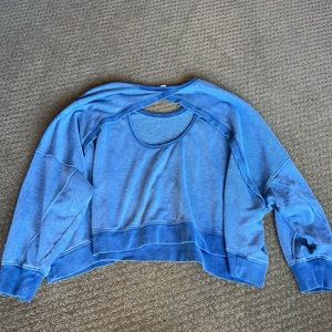 blue sweater with a hole on the back